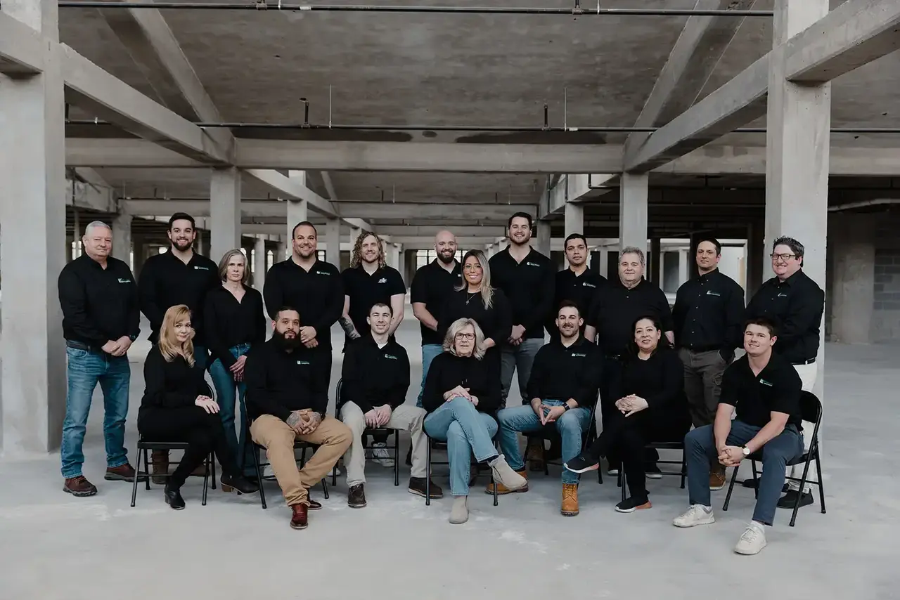 Windward Roofing team members standing in front of a commercial roofing project in Chicago